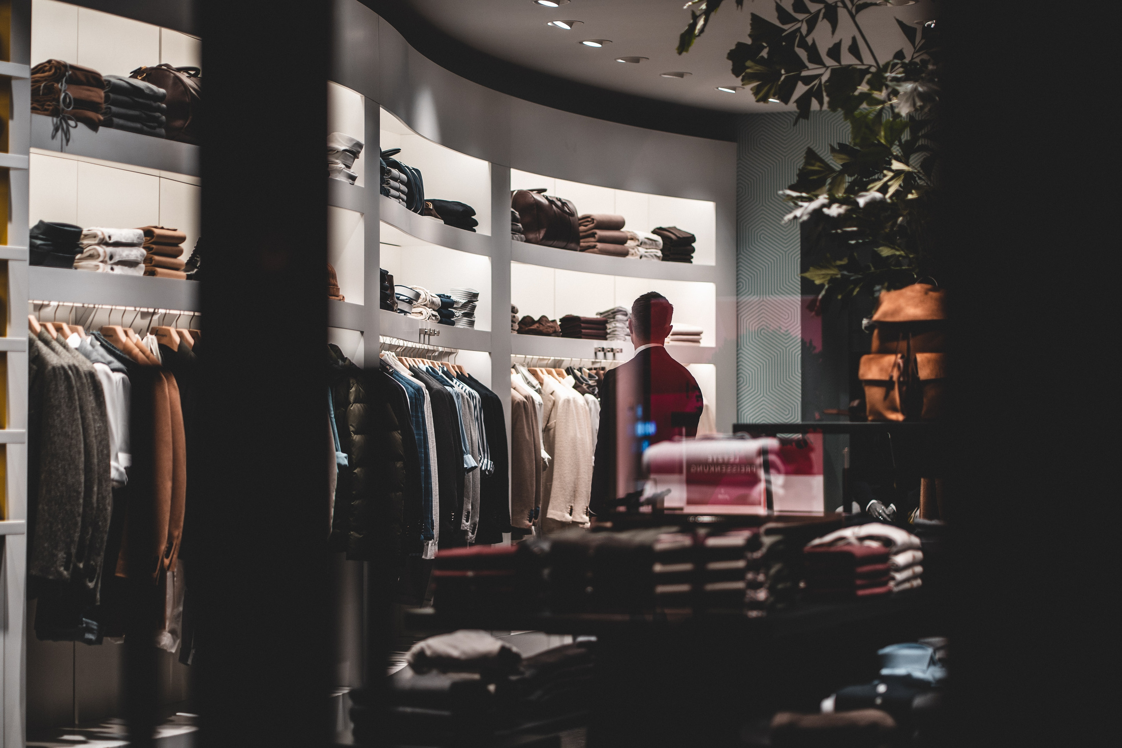 Anonymous stylish man during shopping in fashion store